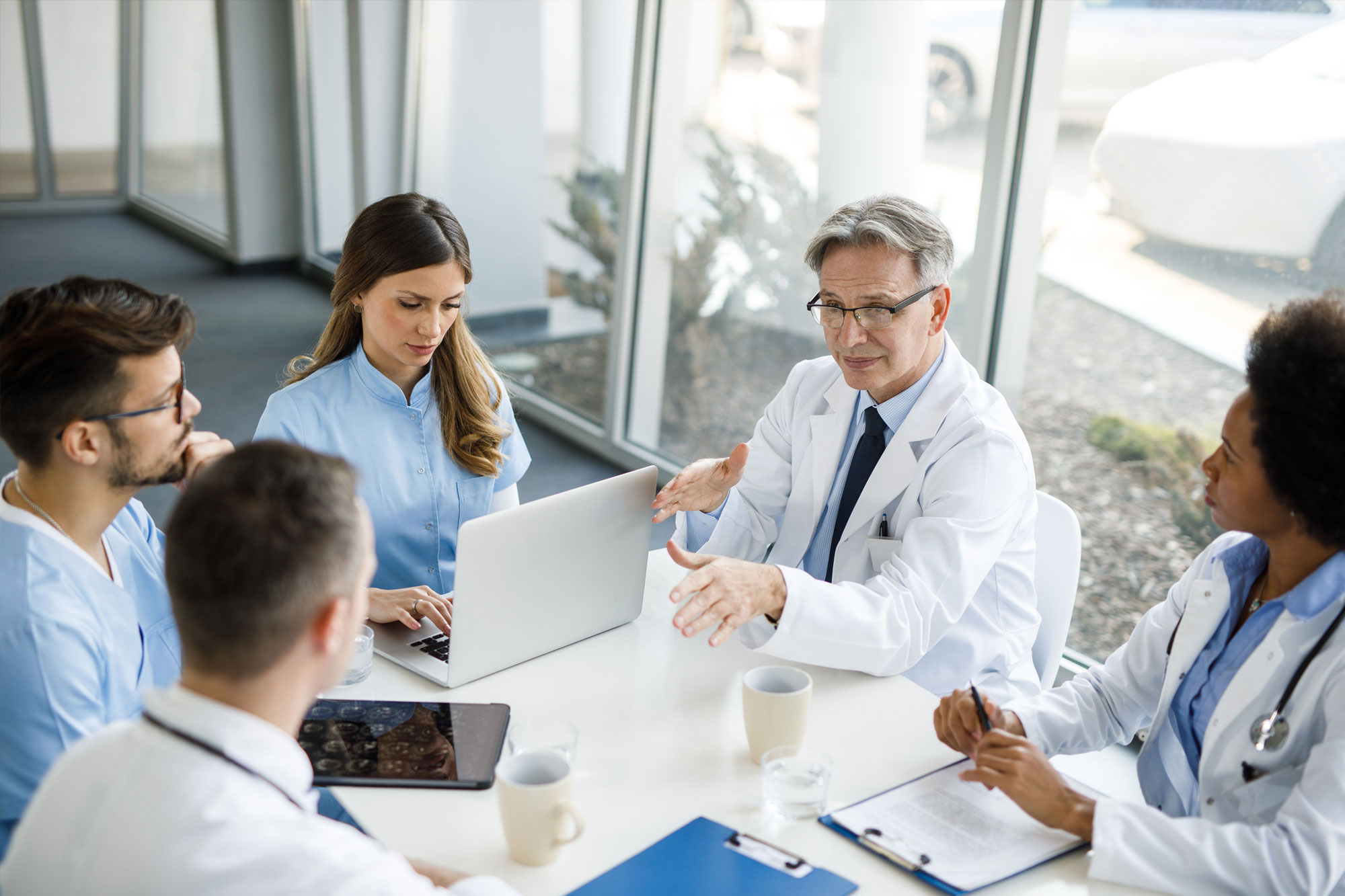 Healthcare providers collaborating on patient care strategy supported by HLA Advisors consulting.